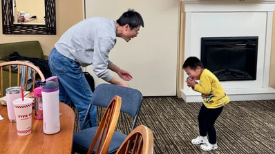 Lin and Philip playing ball with owl plushy